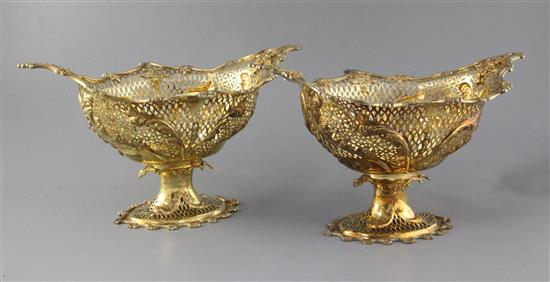 A pair of Edwardian silver gilt oval pedestal dessert baskets, by Herbert Charles Lambert, 56.5 oz.